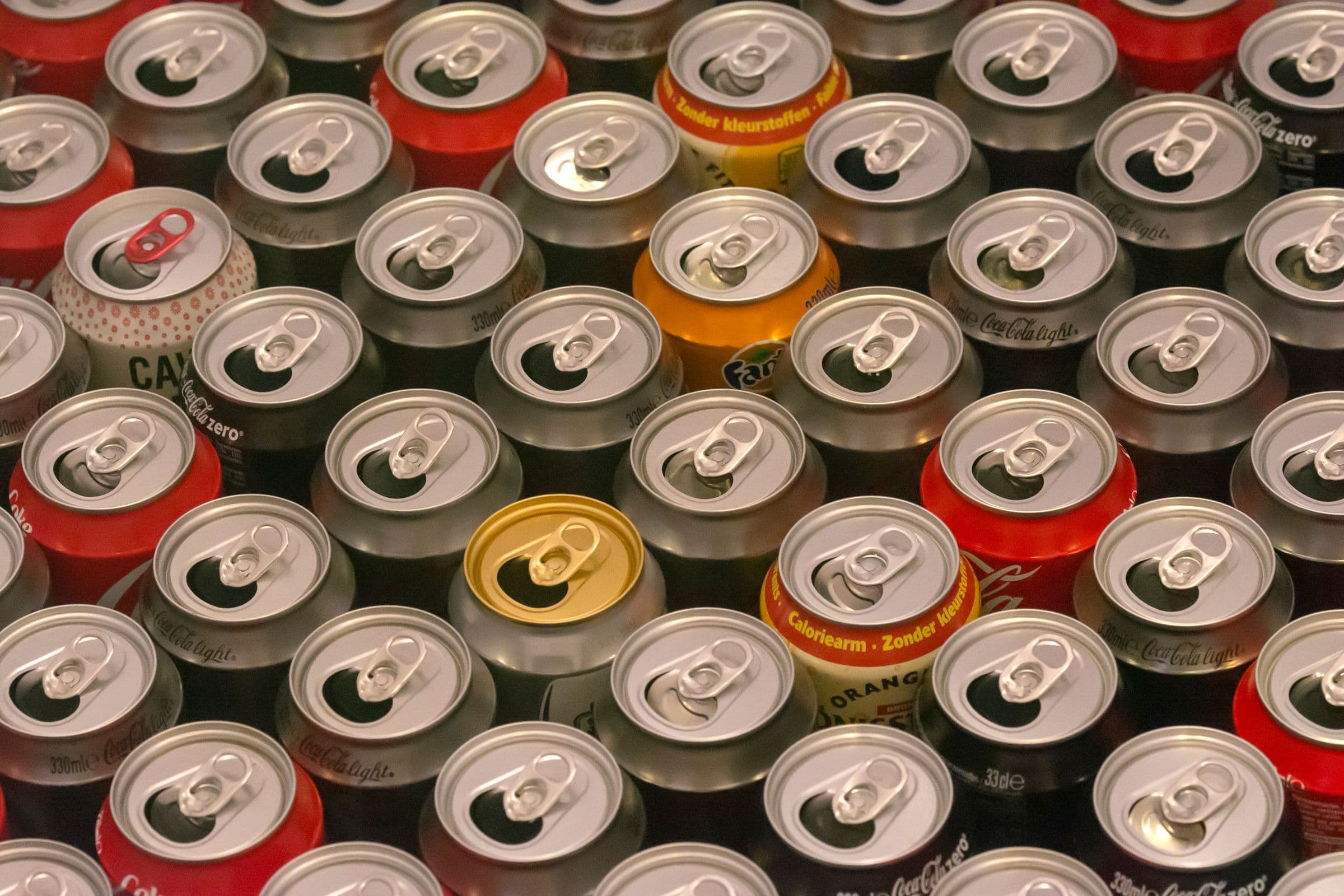 Cans packed shoulder to shoulder in a tray, seen from directly overhead