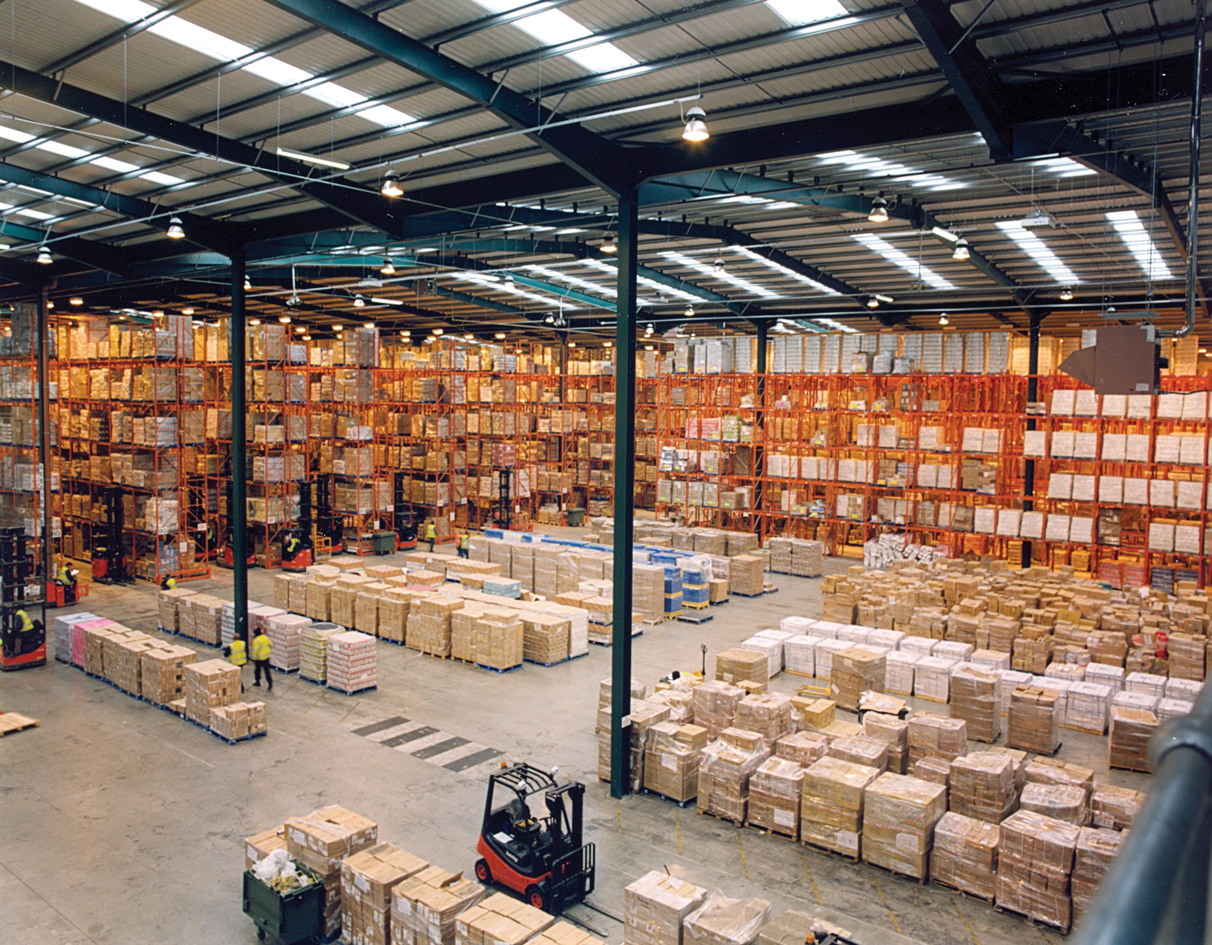Palletised cartons of branded consumer goods in a warehouse, staged for container loading
