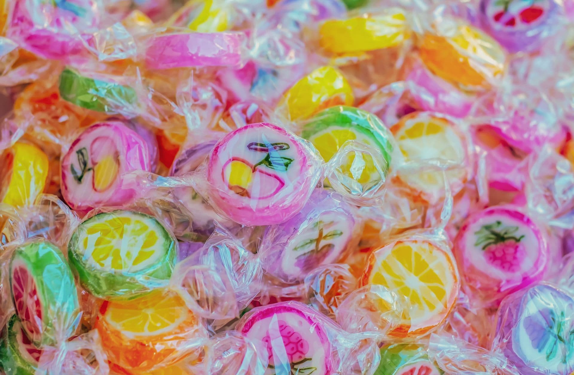 Vibrant close-up of colorful fruit-shaped candies, highlighting texture and sweetness