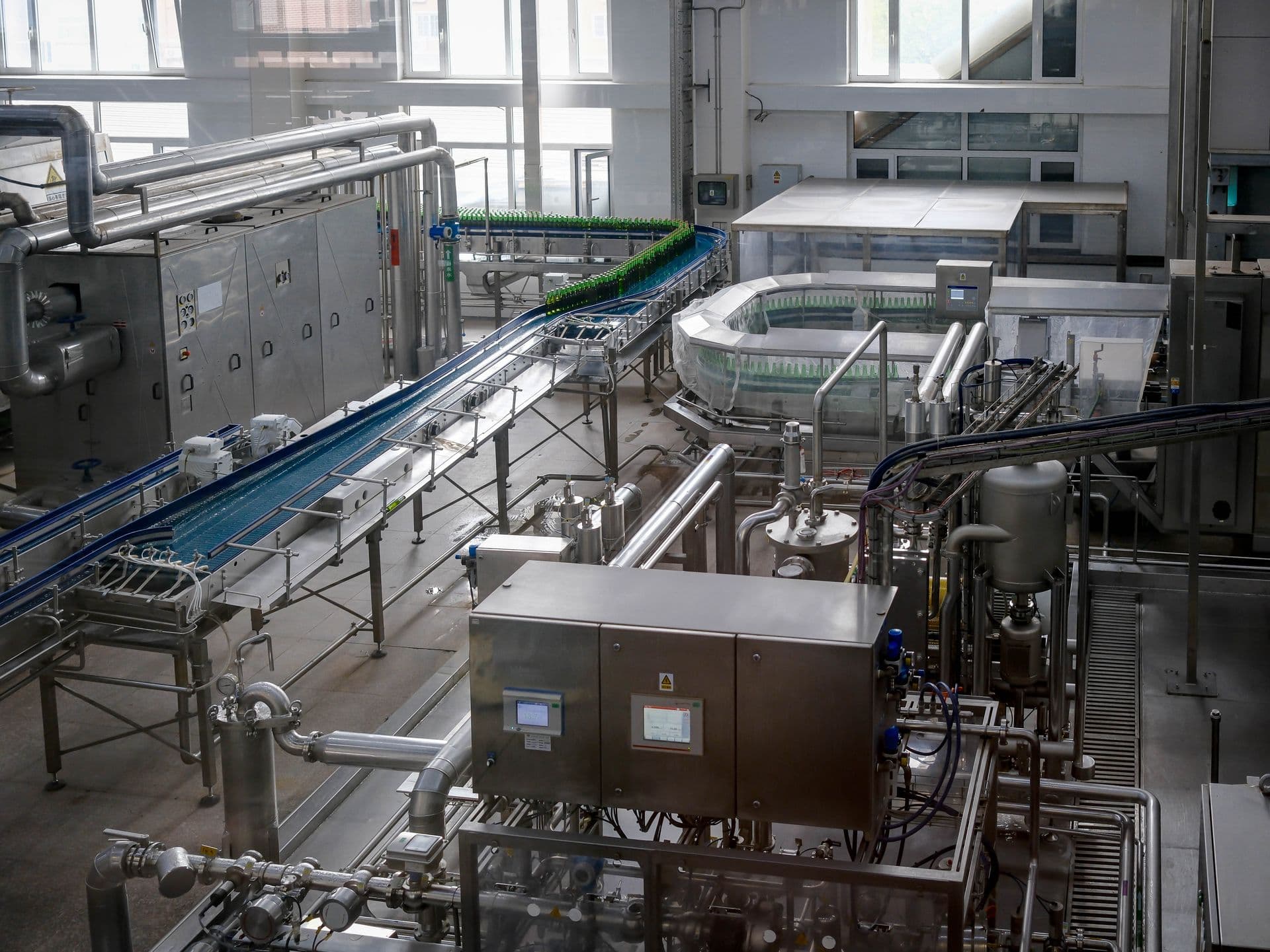 Interior view of an automated food production factory with machinery and conveyor belts