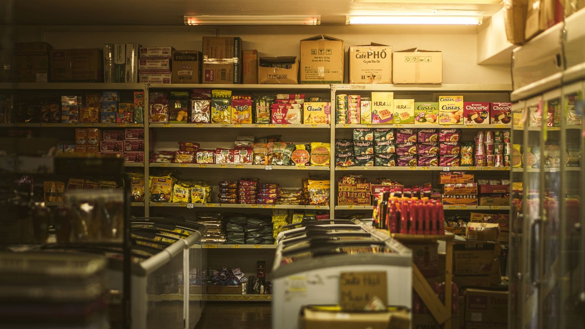 Shelf packed with diverse Asian snacks and groceries in an inviting store setting