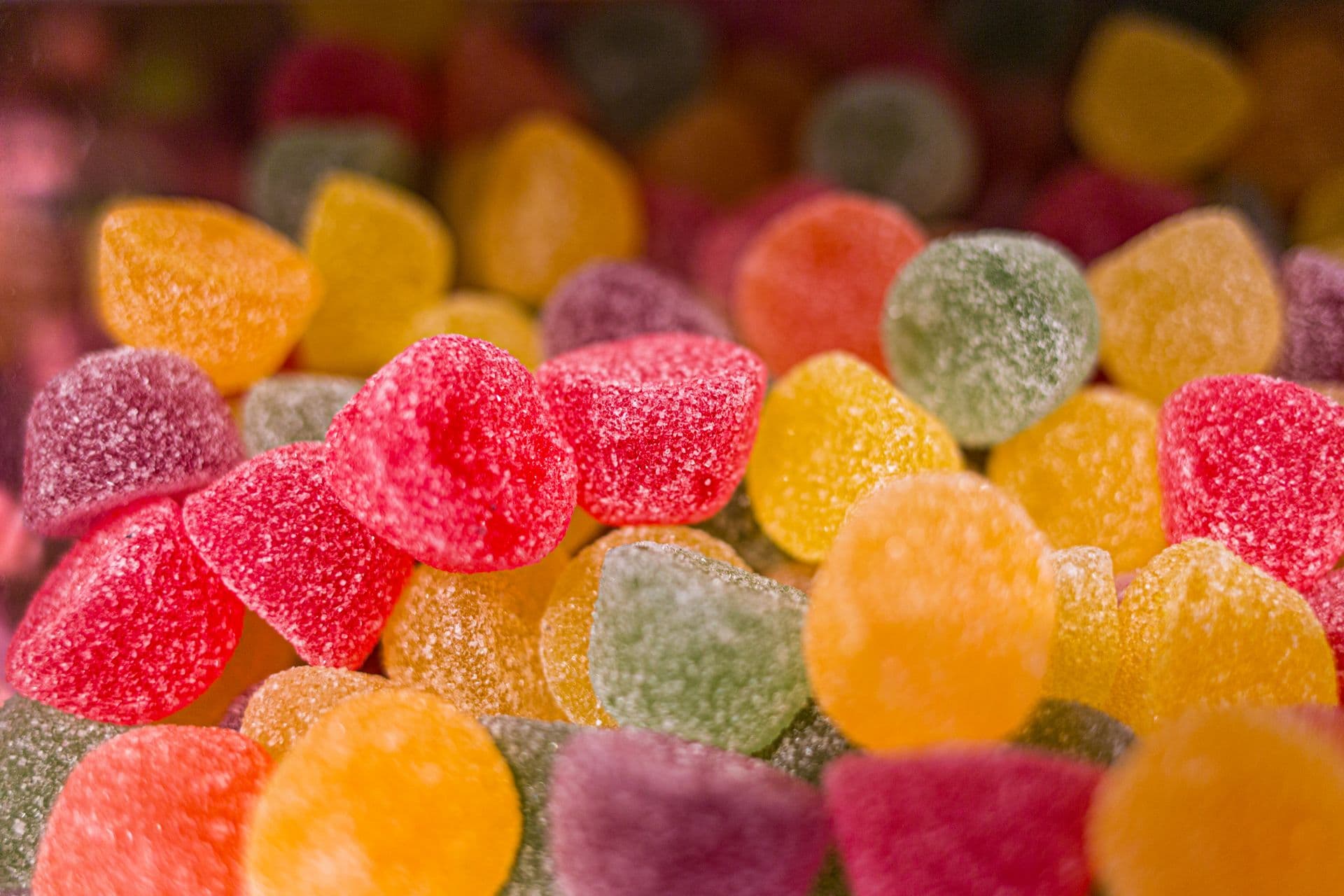 Vibrant close-up of sugar-coated gumdrops showcasing colorful sweet treats.