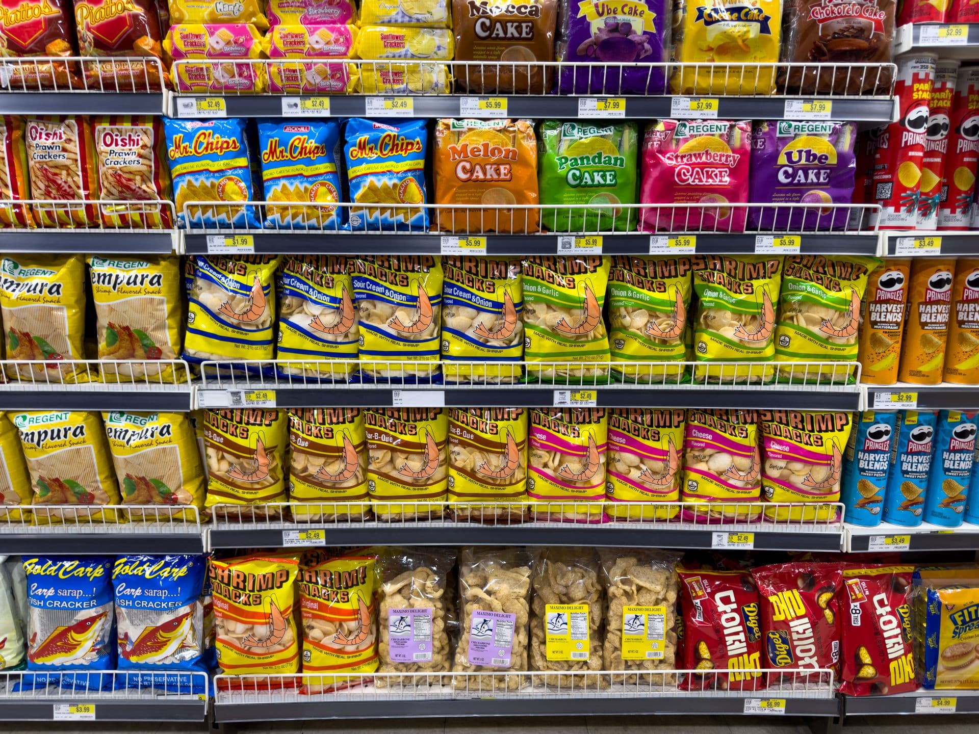Colorful snack packages neatly displayed in a supermarket aisle showcasing Asian food variety.