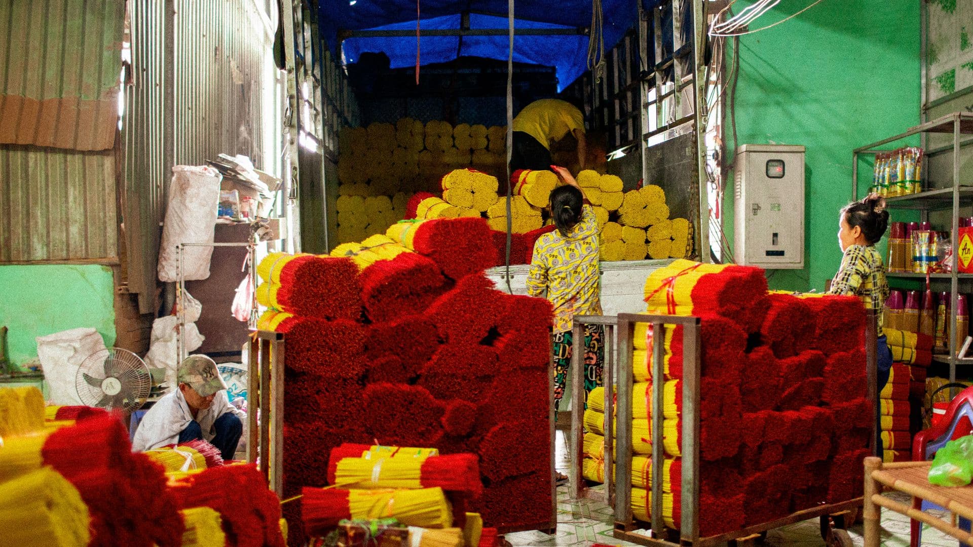 Workers organize vibrant incense sticks in a production facility in Ho Chi Minh City, Vietnam.